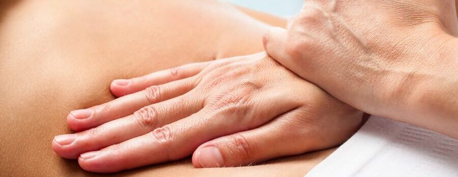 Osteopath hands on abdominal treatment
