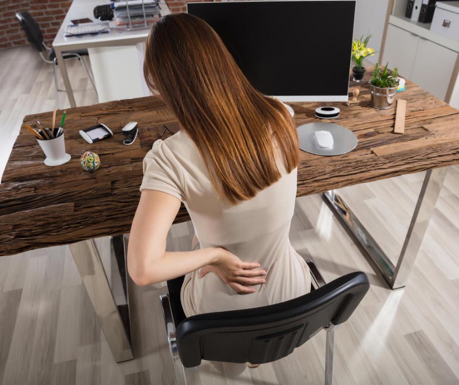 Office worker suffering from back pain due to lower cross syndrome