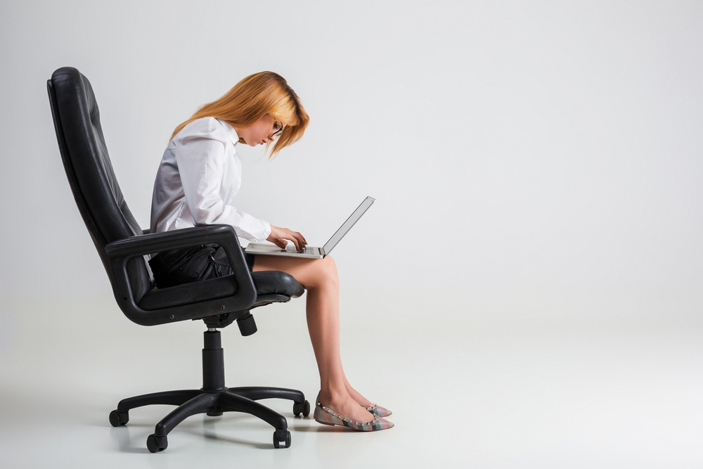 Hunchbacked business woman with upper back pain