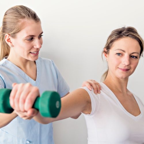 Physiotherapist instructing patient with exercise rehabilitation