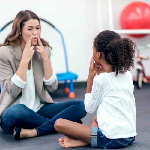 Speech pathologist working with young girl